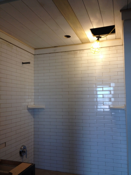 Bathroom tile and planked ceiling