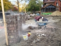 Cutting brick for fence posts.